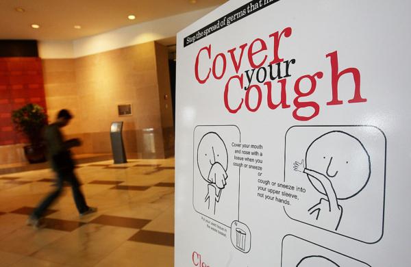 A government-sponsored poster warning of the spread of the flu is posted in an office building in New York City, on Sept. 16, 2009. (Mario Tama/Getty Images)