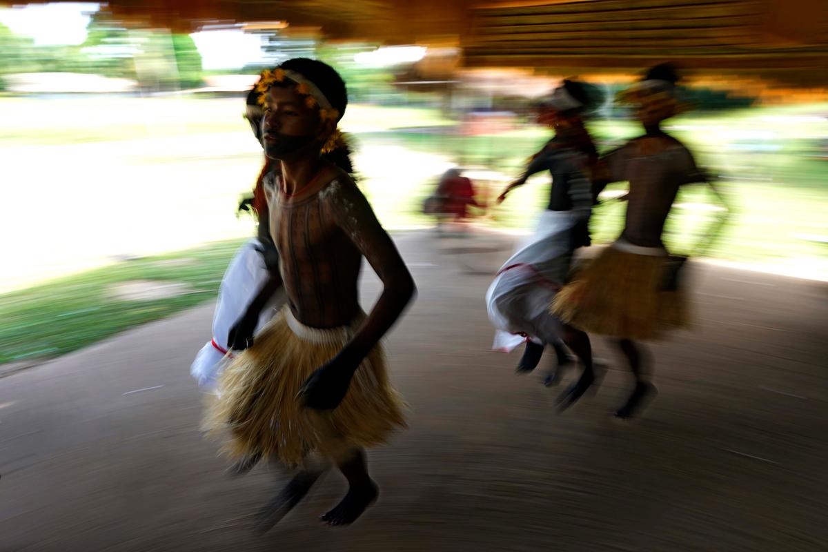 Indigenous Tembé Tenehara adolescents perform the Wyra’whaw rite of passage under a thatched roof in Brazil's Amazon rainforest. (Eraldo Peres/AP Photo)