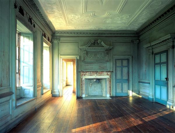 Remnants of the home’s blue-green wall color date to circa 1870, but the original walls were painted a stone-buff hue in the 1700s. The lower Great Hall leads onto the portico and connects to the withdrawing room. (Drayton Hall Preservation Trust)
