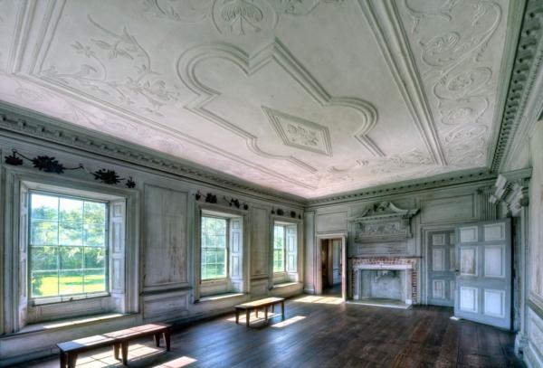Called a “Withdrawing Room,” to which owners and guests withdrew for privacy, the first-floor expansive space boasts such architectural details as dentil moldings, an elaborate hand-carved plaster ceiling, and a decorative, ornately carved wood mantel over a brick fireplace. (Drayton Hall Preservation Trust)