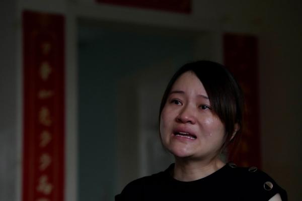 Li Wenzu, wife of disbarred human rights lawyer Wang Quanzhang, cries as she recalls the toll of the escalating harassment on the family especially her 10-year-old child at their apartment in Beijing's Changping district, on June 20, 2023. (Ng Han Guan/AP Photo)