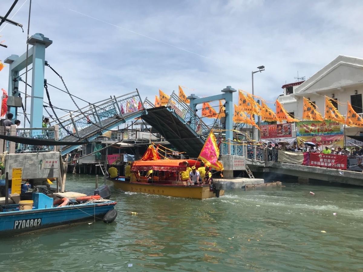 The Dragon Boat Festival in Tai O Fishing Village begins with boats carrying statues of gods sailing under bridges, which are raised as the ships pass to show respect to the gods. (Courtesy of Wong Chi-keung)