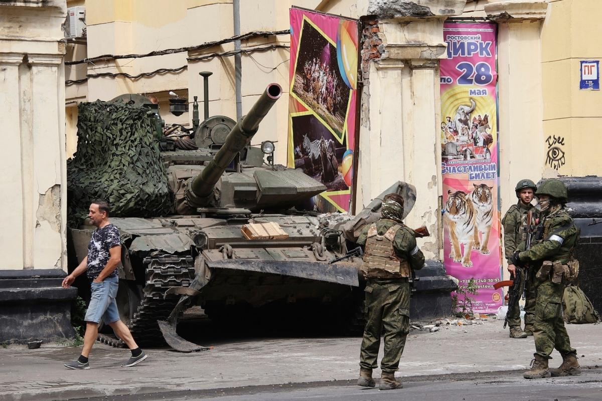 Russian servicemen guard an area standing in front of a tank in a street in Rostov-on-Don, Russia, June 24, 2023. (Vasily Deryugin, Kommersant Publishing House via AP)