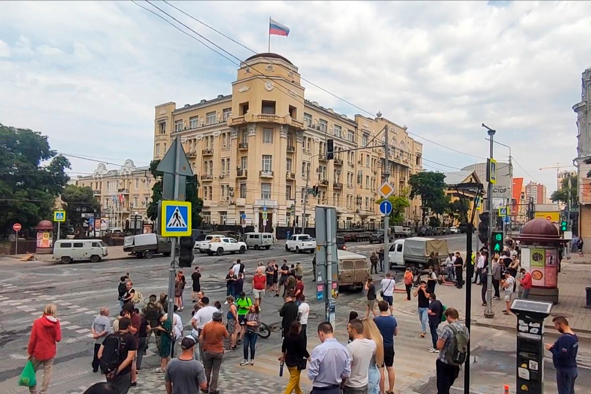 People gather to look at military vehicles parked in a street in Rostov-on-Don, Russia, on June 24, 2023. (AP Photo)