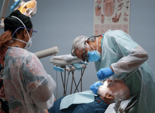 Lestonnac Free Clinic's volunteers provide medical services to a patient in 2021. (Courtesy of Lestonnac Free Clinic)