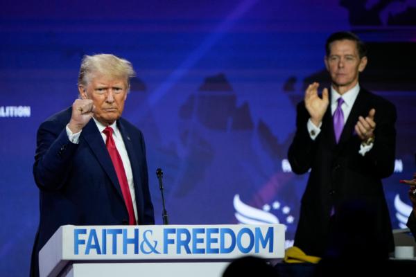 Republican presidential candidate former President Donald Trump concludes his remarks as Chairman of the Faith and Freedom Coalition Ralph Reed applauds at the Faith and Freedom Road to Majority conference at the Washington Hilton in Washington, D.C., on June 24, 2023. (Drew Angerer/Getty Images)