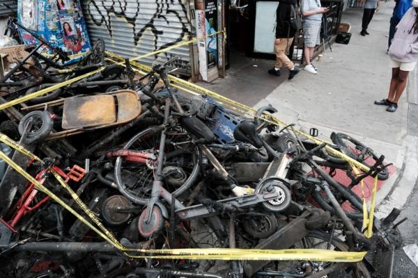 Charred remains of e-bikes and scooters sit outside of a building in Chinatown in New York City on June 20, 2023. (Spencer Platt/Getty Images)