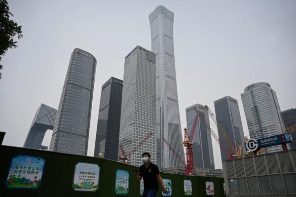 A man walks past the Central Business District in Beijing on May 31, 2023. (Jade Gao/AFP via Getty Images)