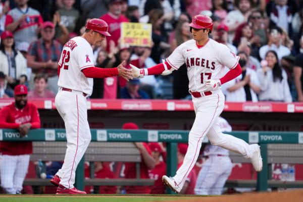 Los Angeles Angels designated hitter Shohei Ohtani (17) is greeted by third base coach Bill Haselman (82) as he runs the bases after hitting a home run during the fourth inning of a baseball game against the Chicago White Sox in Anaheim, Calif., on June 26, 2023. (Ashley Landis/AP Photo)