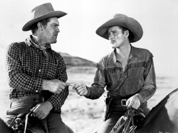 Joe Clemens (Frank McHugh, L) and Wade Hatton (Errol Flynn) in “Dodge City." (MovieStillsDB)