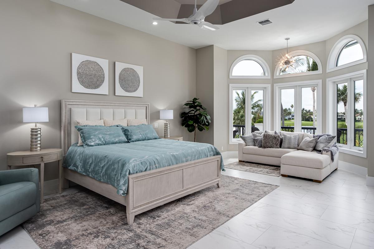 The master bedroom is extraordinarily airy and spacious, with great views of the pool area and golf course beyond. (Courtesy of Andy Frame and Adam Dooms)