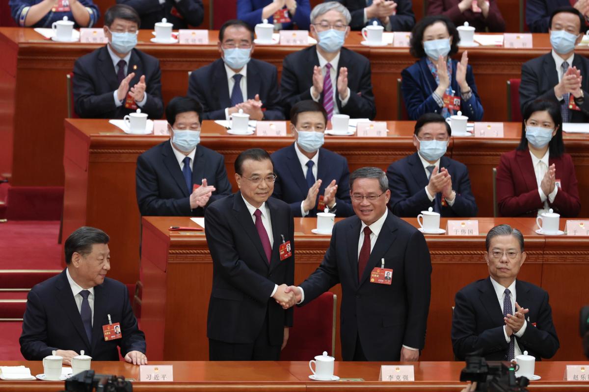 Former Chinese Premier (L2) Li Keqiang shakes hands with Chinese Premier Li Qiang(R) during the fourth plenary session of the National People's Congress in Beijing, China, on March 11, 2023. (Lintao Zhang/Getty Images)