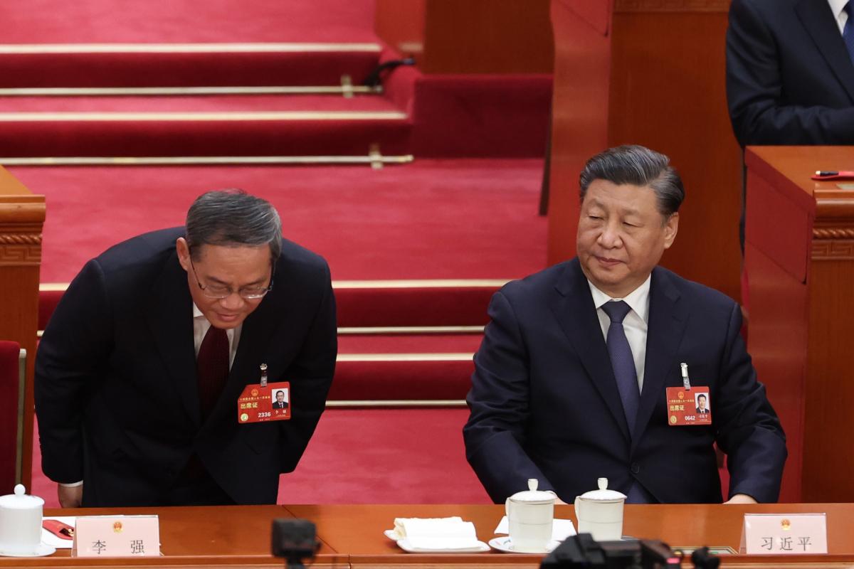 Chinese Premier Li Qiang(L) bows to delegates during the opening of the fourth plenary session of the National People's Congress in Beijing, China on March 11, 2023. (Lintao Zhang/Getty Images)