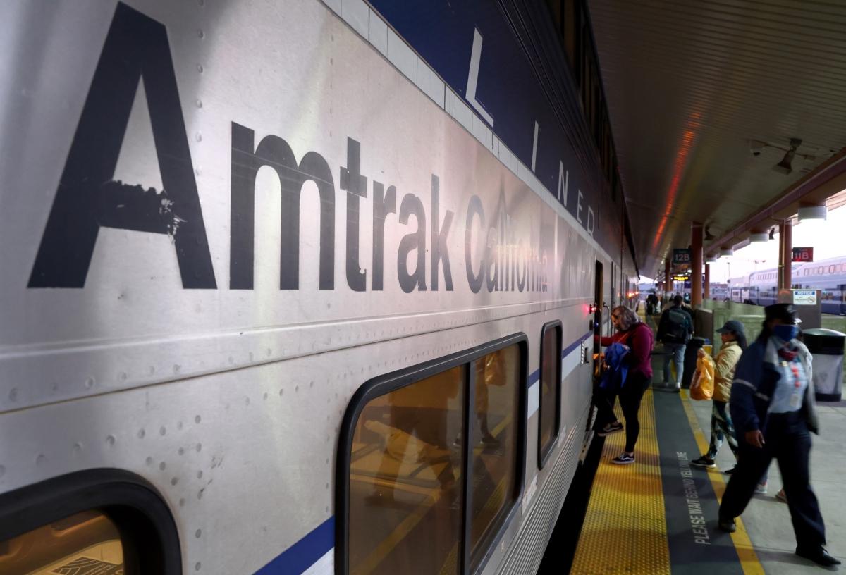 A passenger boards an Amtrak train at Union Station in Los Angeles on Dec. 9, 2021. (Mario Tama/Getty Images)
