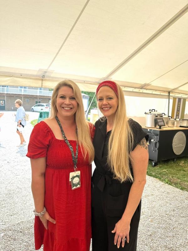 Melissa Renee (left), founder of Handwritten Hills homestead in southwest Ohio, visits with Sarah Thrush, an international canning and food preservation social media influencer, at the Food Independence Summit. (Jeff Louderback/The Epoch Times)