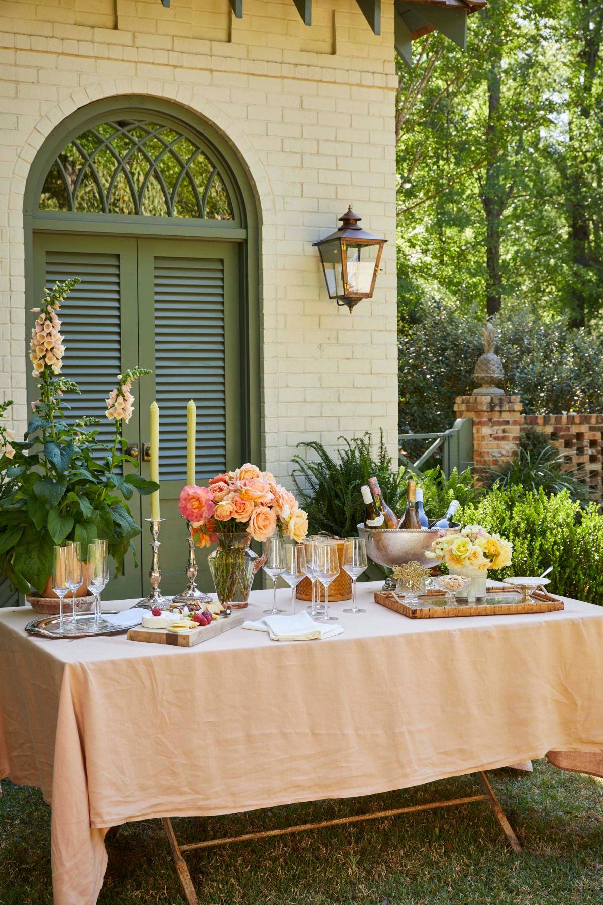 Roses and foxgloves uplift an al fresco table set by interior designer and entertaining expert James T. Farmer. Pictured here in the garden at Farmdale, his home in Perry, Ga. (Emily Followill)