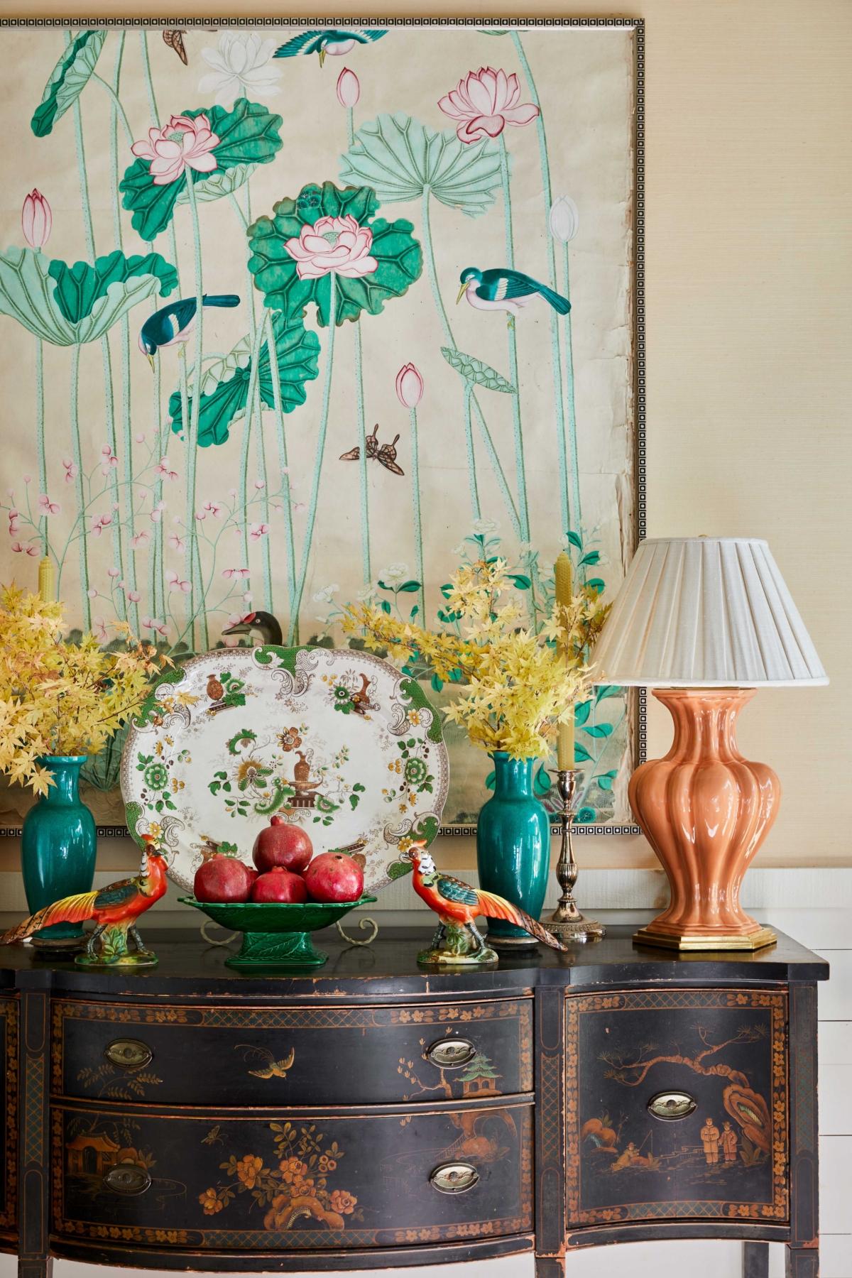 Yellow Japanese maple, antique jade vases, peachy glazed lamps, and pomegranates— part of Farmer’s mother’s family crest—decorate the sideboard in the dining room at Farmdale. (Emily Followill)