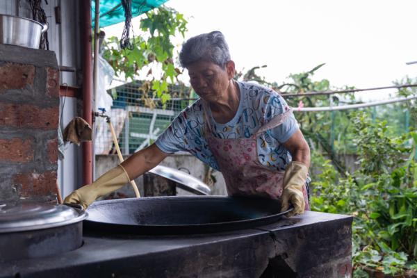<span class="s1">Auntie Ying turns “Commander of Cookery” as she took out a giant iron wok to boil the ash-water dumplings.</span> (Benson Lau/The Epoch Times)