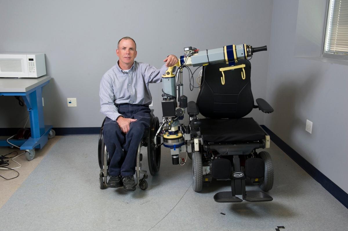Cooper with his invention, a Mobility Enhancement Robotic Wheelchair (MEBot) that allows the disabled to explore rugged terrain. (Courtesy of Dr. Rory Cooper）