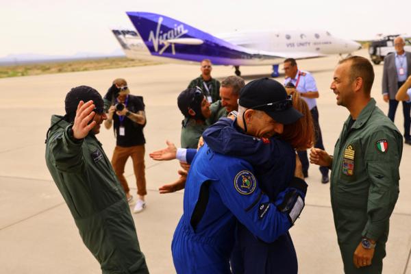 Crew members are congratulated as they return from Virgin Galactic's rocket plane first commercial flight to the edge of space, at the Spaceport America facility, in Truth or Consequences, N.M., on June 29, 2023. (Jose Luis Gonzalez/Reuters)