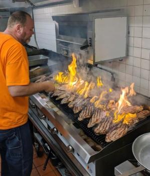 Darin Agnew, then-owner of Searles on Fifth Avenue in St. Cloud, Minn., cooks steaks for firefighters in February 2020. (Courtesy Michelle Agnew)