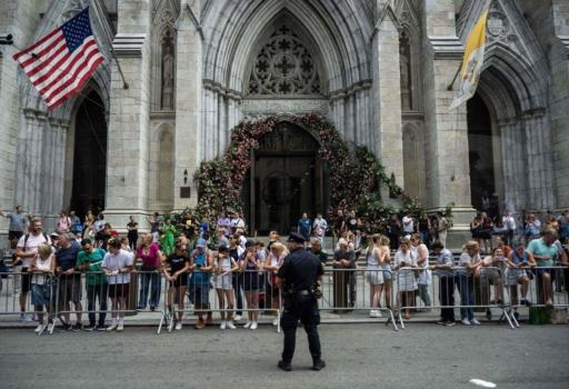 People watch as the motorcade of President Joe Biden passes St. Patrick's Cathedral on June 29, 2023 in midtown Manhattan in New York City, where he will attend fundraisers. (Andrew Caballero-Reynolds/AFP via Getty Images)