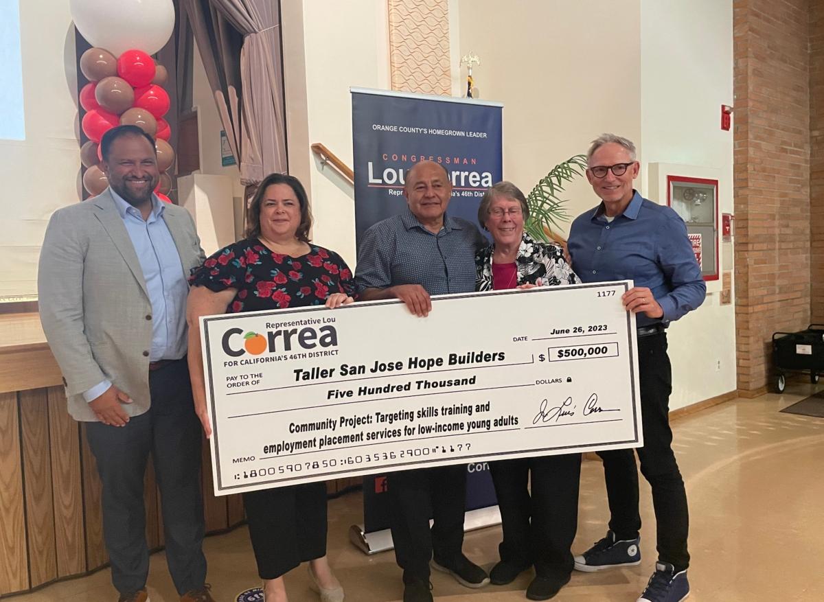 Rep. Lou Correa (D-Calif.) awards a $500,000 check to Hope Builders at a ceremony at Sisters of Saint Joseph in Orange, Calif., on June 26, 2023. (Carol Cassis/The Epoch Times)