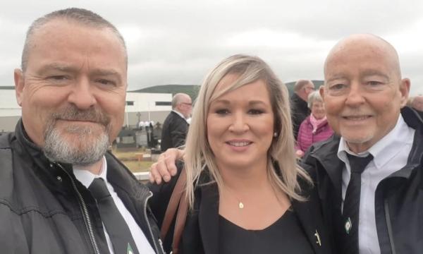 Sinn Fein's leader in Northern Ireland, Michelle O'Neill (C) posing for a selfie with two unidentified men at the funeral of IRA man Bobby Storey in Belfast, Northern Ireland, on June 30, 2020. O'Neill was Tony Doris's cousin. (Sinn Fein/PA)