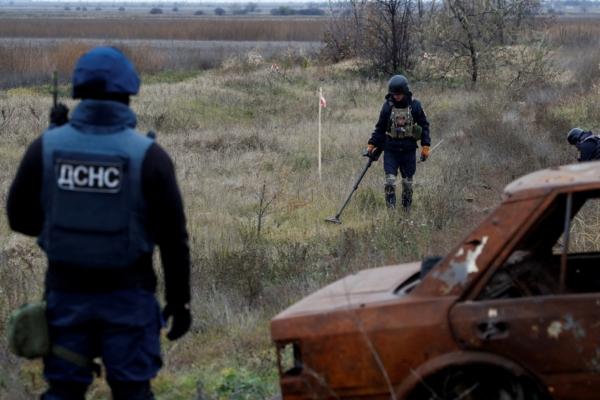 Ukrainian mine experts scan for unexploded ordnance and landmines by the main road to Kherson, Ukraine, on Nov. 16, 2022. (Murad Sezer/Reuters)
