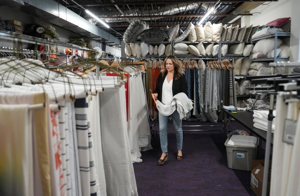 Laurie Flemming collects a blanket for a future staging project for a client at Flemming's home staging company Fix Design Haus in Plymouth, Minnesota, on June 5, 2023. (Renée Jones Schneider/Minneapolis Star Tribune/TNS)