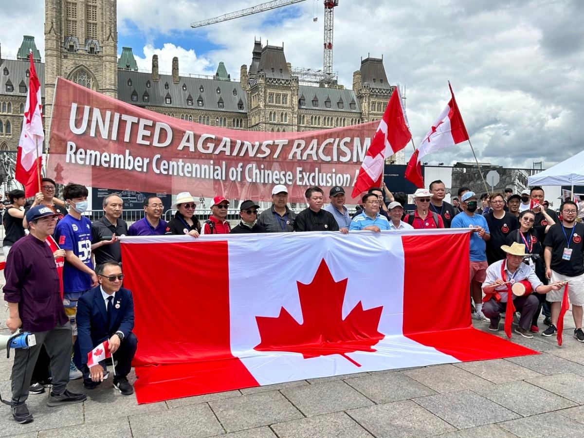 Weng Guoning (9th L), the permanent honorary president of the Canada Toronto Fuqing Business Association, is seen among the key organizers of a rally on Parliament Hill in Ottawa on June 24, 2023. (The Epoch Times)