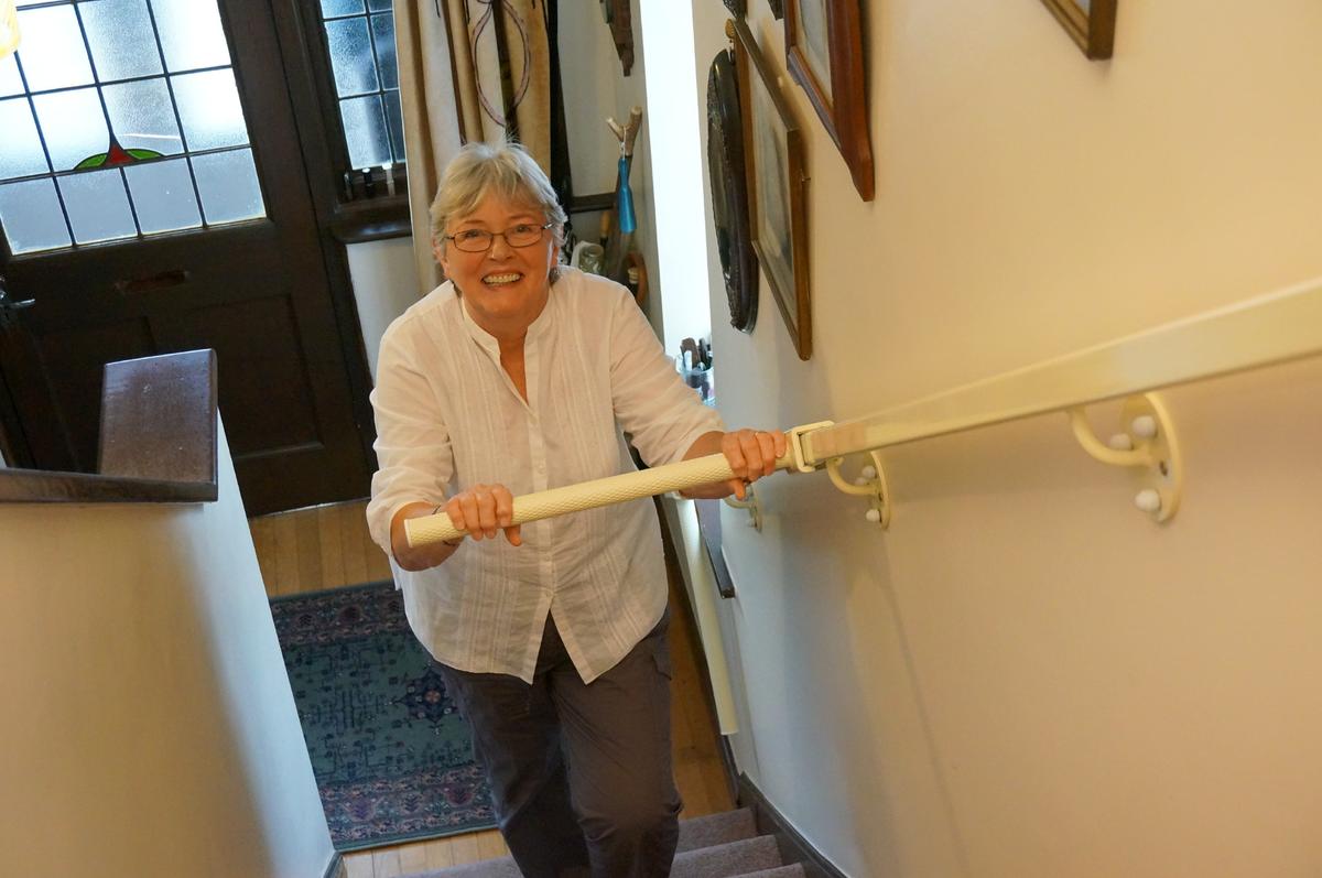 A woman using the StairSteady. (Courtesy of <a href="https://www.ruthamos.com/">Ruth Amos</a>)