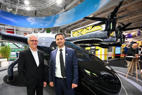 Archer's founder and CEO Adam Goldstein (R) poses next to Stellantis CEO Carlos Tavares (L) in front of the Midnight Archer aircraft during the International Paris Air Show at the ParisLe Bourget Airport, on June 19, 2023. (Emmanuel Dunand/AFP via Getty Images)