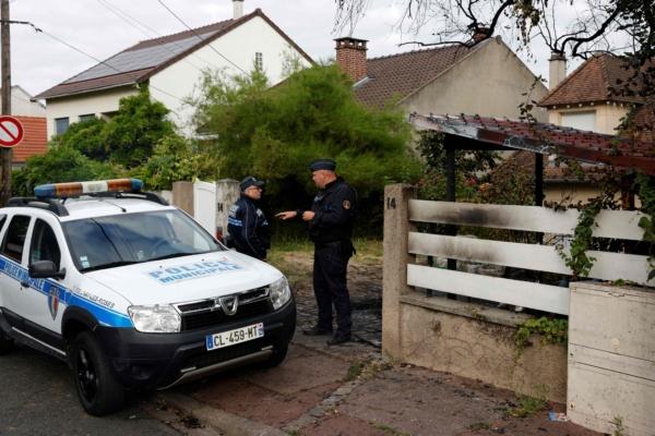 Municipal police officers stand in front of the damaged home of the Mayor of l'Hay-les-Roses Vincent Jeanbrun, in l'Hay-les-Roses, a suburb of Paris, on July 2, 2023. (Geoffroy Van Der Hasselt/AFP via Getty Images)