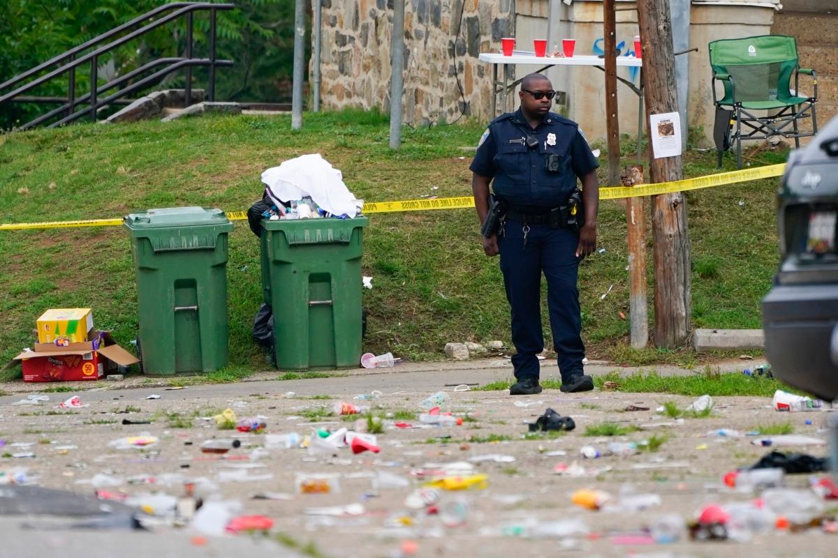 A police officer stands in the area of a shooting incident in the Southern District of Baltimore on July 2, 2023. (Julio Cortez/AP Photo)