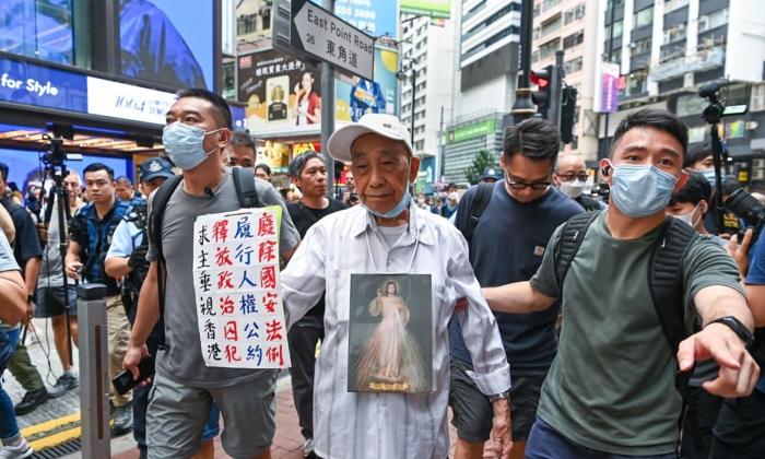 Hong Kong Police on High Security Alert, 87-Year-Old Slogan Bearer Escorted Away on Anniversary of July 1