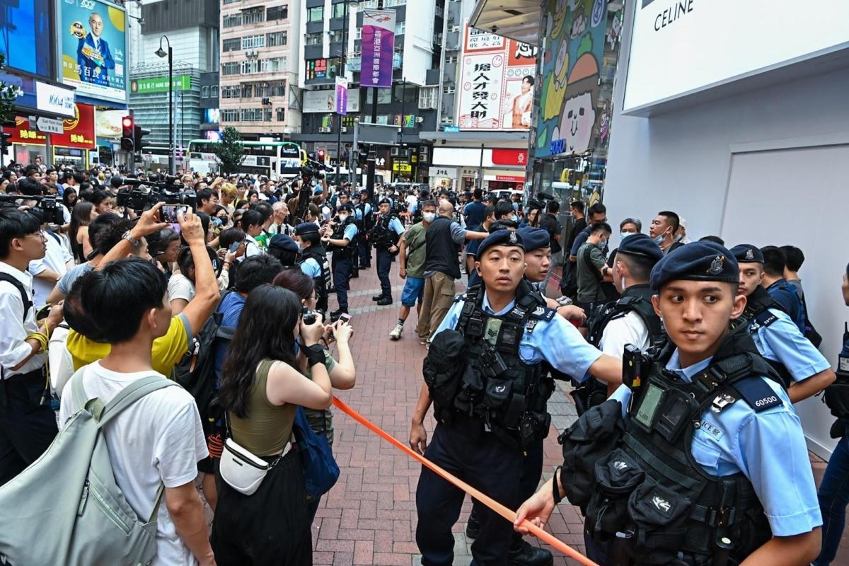 The police pulled up an orange ribbon outside SOGO in Causeway Bay, cordoned the area, and stopped and searched an 87-year-old man on July 1, 2023. (Sung Pi-Lung/The Epoch Times)