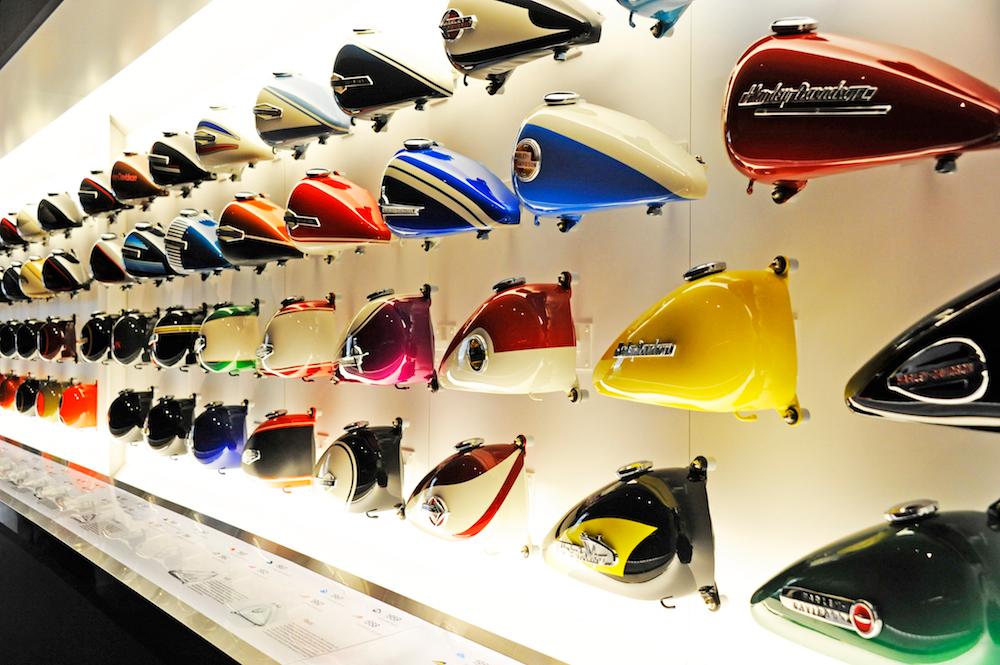 A wall showcases the most iconic tanks produced by the company. (Courtesy of the Harley-Davidson Museum)