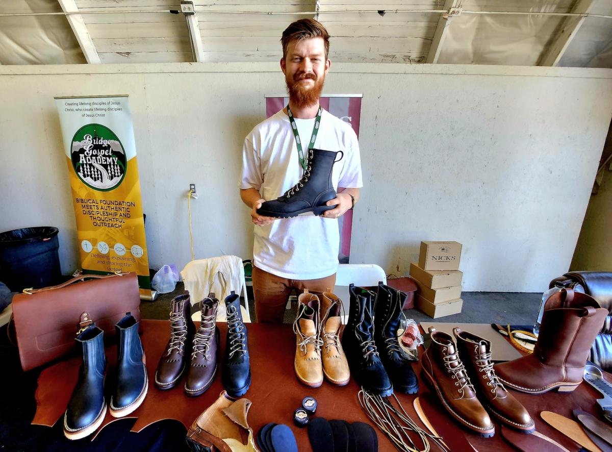 Nathan Kromer, senior brand manager at Nick's Handmade Boots in Spokane Valley, Washington holds a boot made from pure leather in the United States on July 1, 2023. (Allan Stein/The Epoch Times)