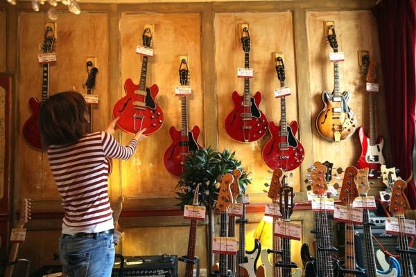 An employee sorts a display of vintage guitars in a shop on Denmark Street in London, England, on April 20, 2011. (Dan Kitwood/Getty Images)