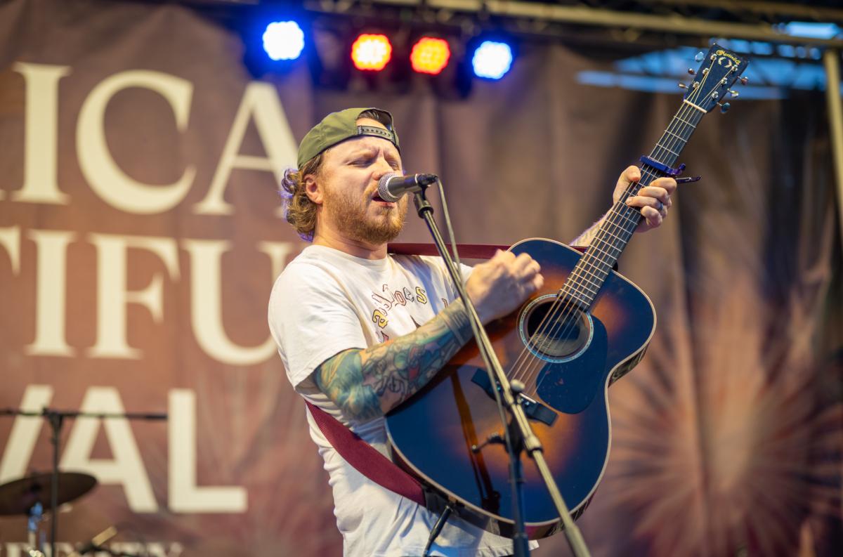 Zach Myers performs with Allen Mack Myers Moore at the America the Beautiful Festival in Deerpark, N.Y., on July 2, 2023. (Mark Zou/The Epoch Times)