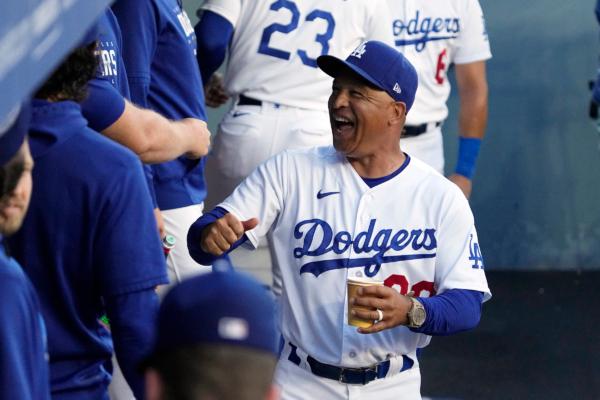 Los Angeles Dodgers manager Dave Roberts laughs as he walks through the dugout prior to a baseball game against the Pittsburgh Pirates in Los Angeles on July 3, 2023. (Mark J. Terrill/AP Photo)