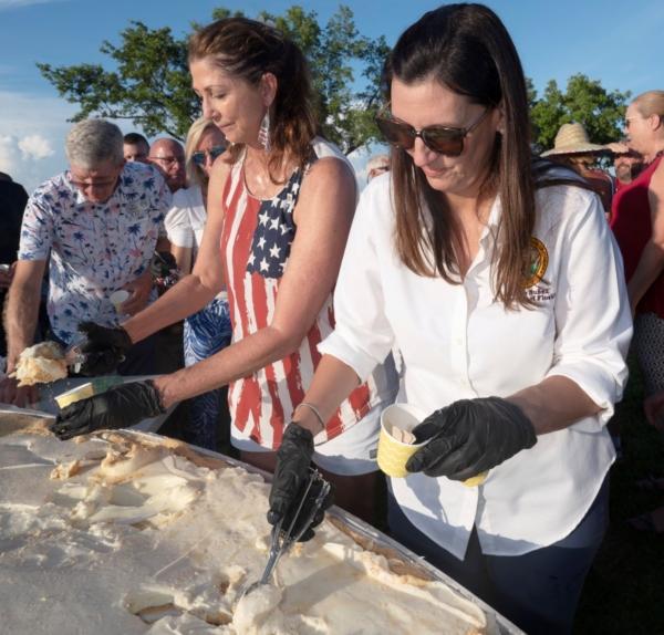 (L–R) Monroe County Commissioners Jim Scholl and Michelle Lincoln, along with Florida Lt. Governor Jeanette Nunez, serve Key lime pie to attendees at a 200th Florida Keys birthday celebration on Big Pine Key, Fla., on July 3, 2023. (Andy Newman/Florida Keys News Bureau via AP)
