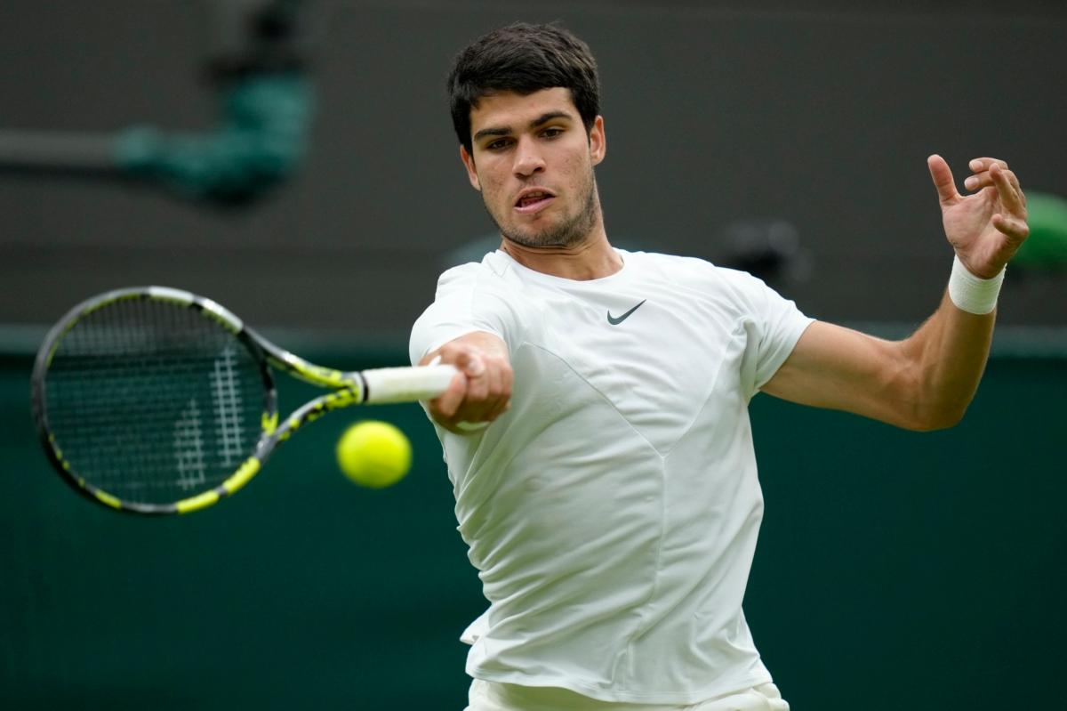 Spain's Carlos Alcaraz returns to Jeremy Chardy of France in a first round men's singles match on day two of the Wimbledon tennis championships in London on July 4, 2023. (Kirsty Wigglesworth/AP Photo)