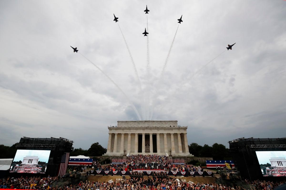 President Donald Trump, First Lady Melania Trump, Vice President Mike Pence, and Second Lady Karen Pence and others stand as the U.S. Army Band performs and the U.S. Navy Blue Angels flyover at the end of an Independence Day celebration in front of the Lincoln Memorial in Washington on July 4, 2019. (Alex Brandon/AP Photo)