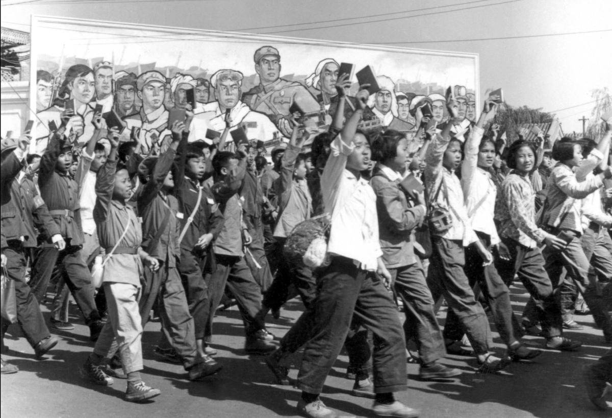 Red Guard members wave copies of Chairman Mao’s “Little Red Book” during a parade in Beijing in June 1966. (Jean Vincent/AFP via Getty Images)