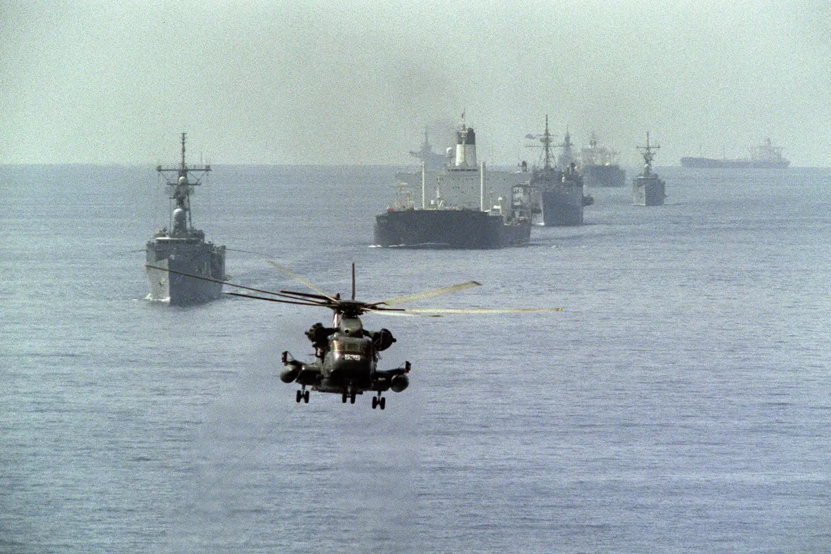 A U.S. Navy minesweeping helicopter leads the way for the 12th U.S. reflagged Kuwaiti tanker convoy on Oct. 22, 1987. (Norbert Schiller/AFP via Getty Images)