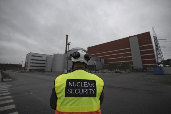 A security agent stands in front of the OL3, the latest among three reactors at the nuclear power plant Olkiluoto on the island of Eurajoki, western Finland, on Oct. 5, 2022. (Olivier Morin/AFP via Getty Images)