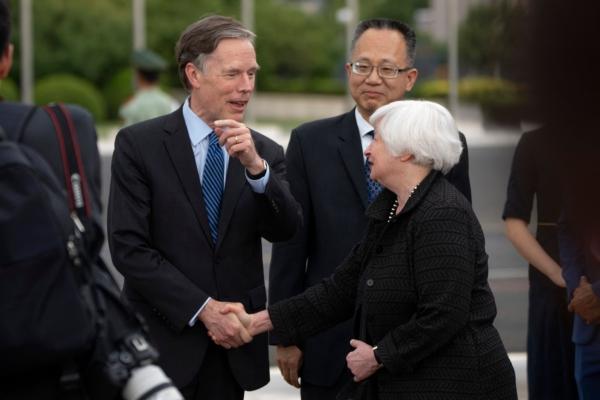 U.S. Treasury Secretary Janet Yellen (R) shakes hands with U.S. Ambassador to China Nicholas Burns (L) as Chinese official Yang Yingming looks on after Yellen arrived at Beijing Capital International Airport on July 6, 2023. (Mark Schiefelbein/POOL/AFP via Getty Images)