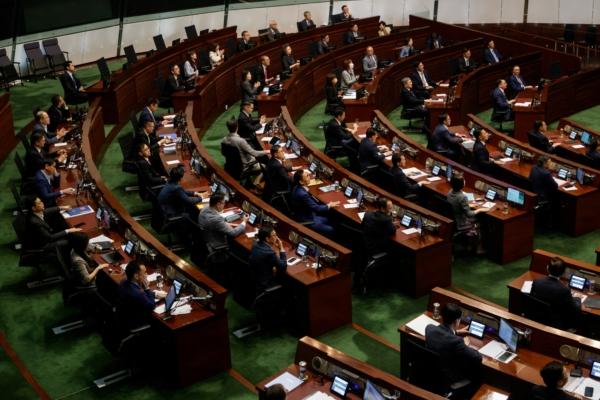 Legislators vote for the third reading of the District Councils (Amendment) Bill, which pertains to electoral overhaul, at the Legislative Council in Hong Kong on July 6, 2023. (Tyrone Siu/Reuters)